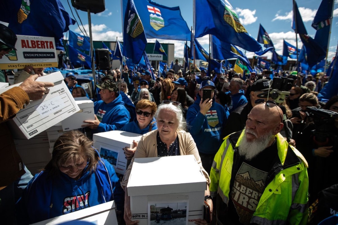 Supporters carrying petition boxes