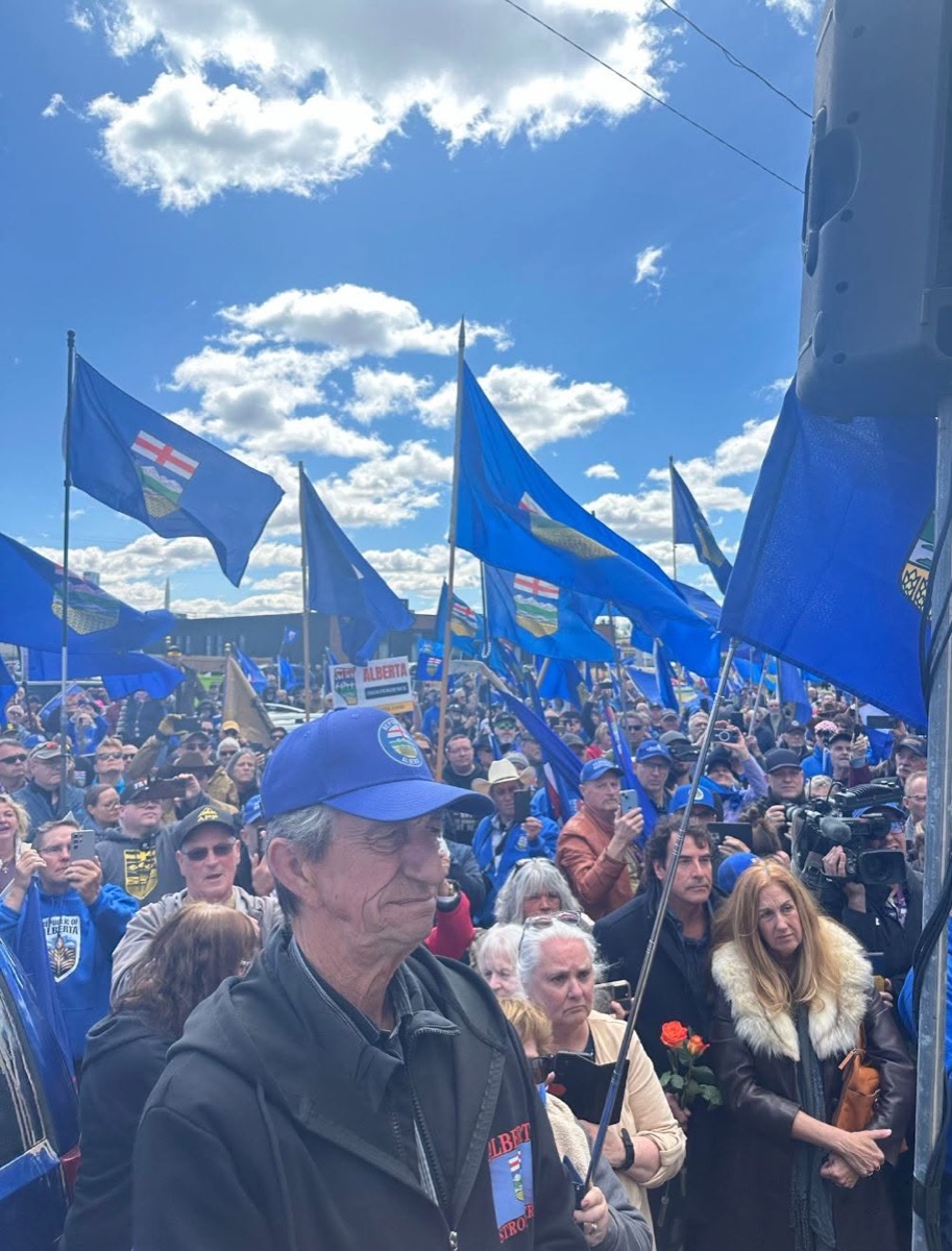 Crowd of supporters with Alberta flags at the delivery