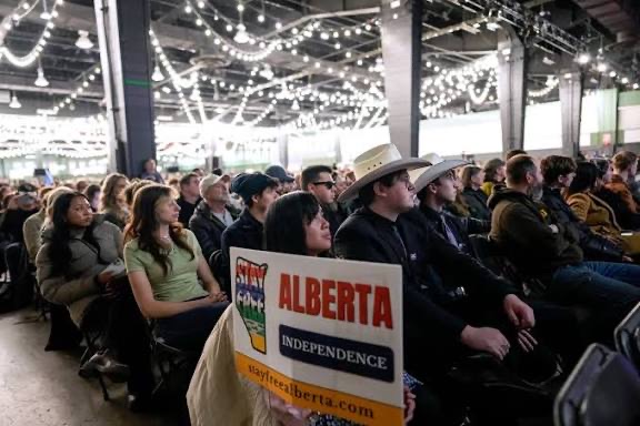 Town hall audience with an Alberta Independence sign
