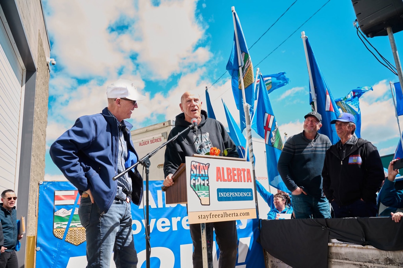 Mitch Sylvestre speaking at the Stay Free Alberta podium